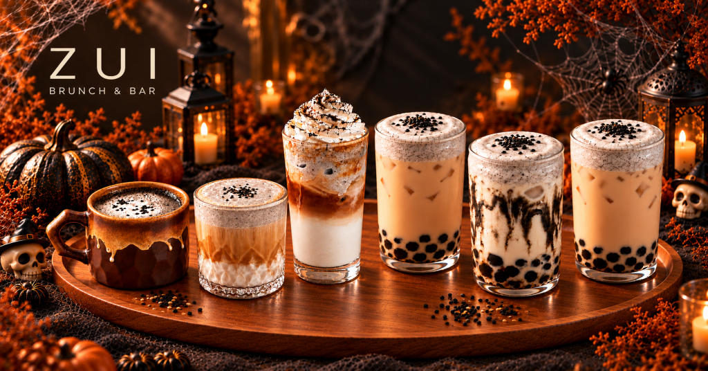 Six black sesame drinks, including coffee, milk tea and brown sugar milk, in a Halloween setting at ZUI Brunch & Bar Budapest.